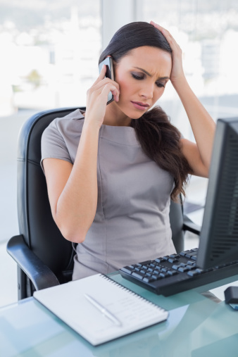 Worried businesswoman having a phone call